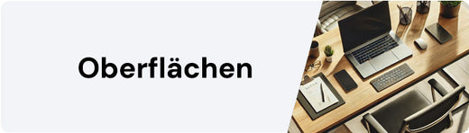 Moderner Arbeitsplatz mit Laptop und Schreibutensilien auf Schreibtisch, beschriftet mit "Oberflächen".